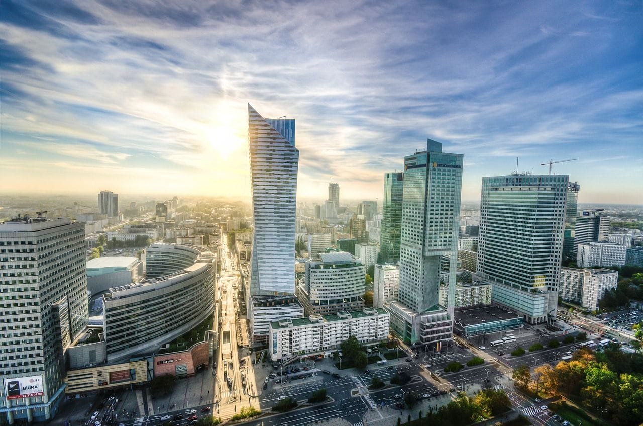 Centrum Warszawy o poranku. Widoczne wieżowce, w tym Złota 44 i InterContinental. Jasne, lekko zachmurzone niebo